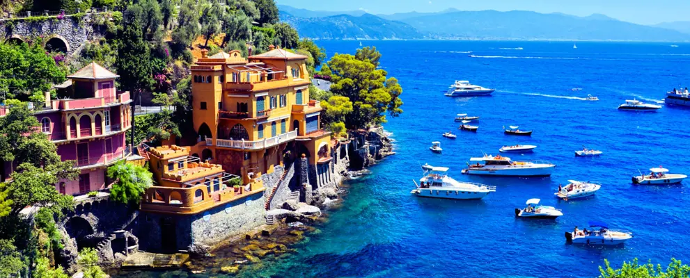 Luxurious seaside villas of Portofino, Italy. Scenic cove with boats in the Mediterranean Sea.